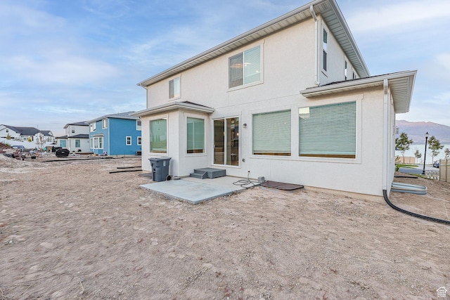 2867 S Greenhead Dr, Saratoga Springs, UT 84045 - rear view of house featuring a patio area, entry steps, stucco siding, and a mountain view