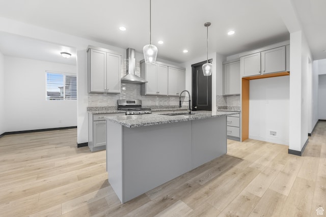 2867 S Greenhead Dr, Saratoga Springs, UT 84045 - kitchen with a sink, gray cabinetry, wall chimney exhaust hood, and stove