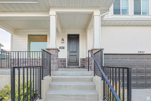 2867 S Greenhead Dr, Saratoga Springs, UT 84045 - view of exterior entry featuring an attached garage and covered porch