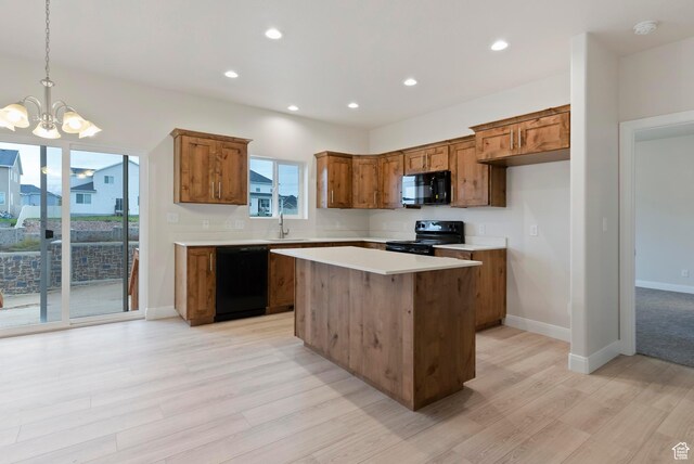 1696 S Windsong Dr Unit 362, Santaquin, UT 84655 - kitchen featuring hanging light fixtures, black appliances, light hardwood / wood-style floors, and a center island