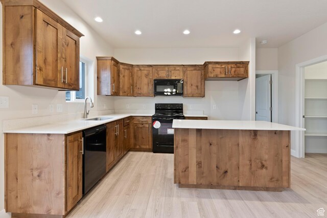 1696 S Windsong Dr Unit 362, Santaquin, UT 84655 - kitchen featuring light wood-type flooring, black appliances, a center island, and sink