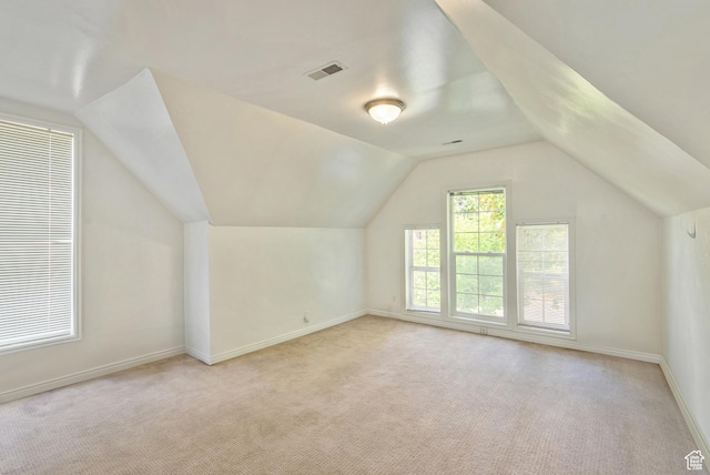 48 E 200 N, Salt Lake City, UT 84103 - additional living space with visible vents, baseboards, light colored carpet, and vaulted ceiling