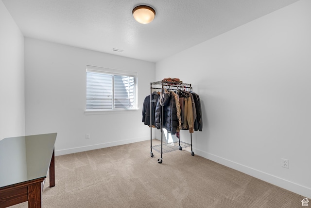 walk in closet with visible vents and carpet floors