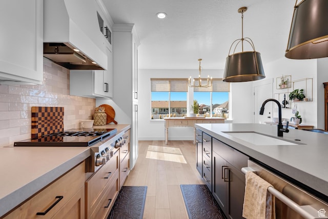 kitchen featuring custom range hood, a sink, stainless steel appliances, light countertops, and recessed lighting