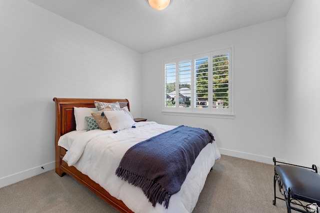 bedroom with carpet and baseboards