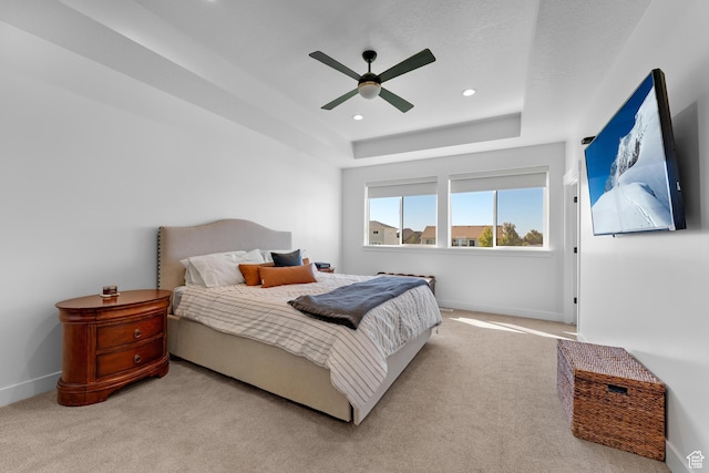 carpeted bedroom featuring recessed lighting, a ceiling fan, a raised ceiling, and baseboards