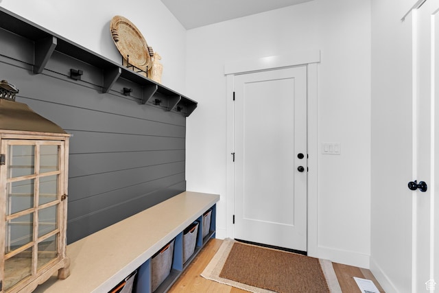 mudroom featuring visible vents, baseboards, and light wood-type flooring