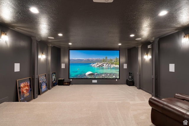 home theater room with ornate columns, recessed lighting, and carpet flooring