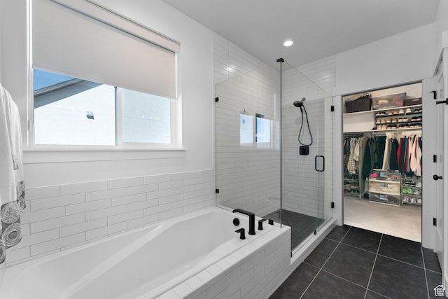 bathroom with recessed lighting, tile patterned floors, a shower stall, a bath, and a spacious closet