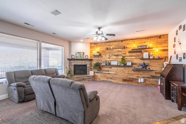 2042 Westcliff Dr, St George, UT 84790 - carpeted living area with visible vents, wood walls, a fireplace, and ceiling fan