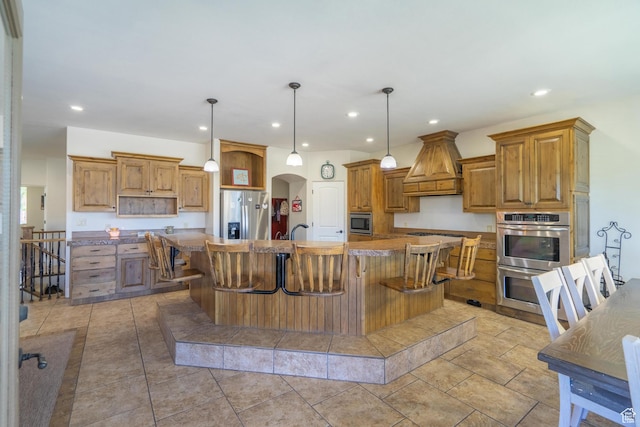 2042 Westcliff Dr, St George, UT 84790 - kitchen featuring arched walkways, appliances with stainless steel finishes, custom exhaust hood, and recessed lighting