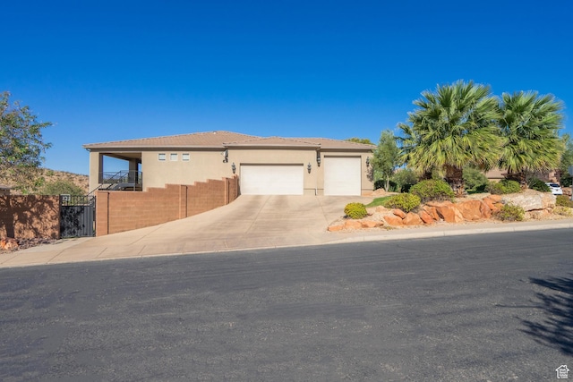 2042 Westcliff Dr, St George, UT 84790 - view of front facade featuring a gate, fence, stucco siding, driveway, and a garage