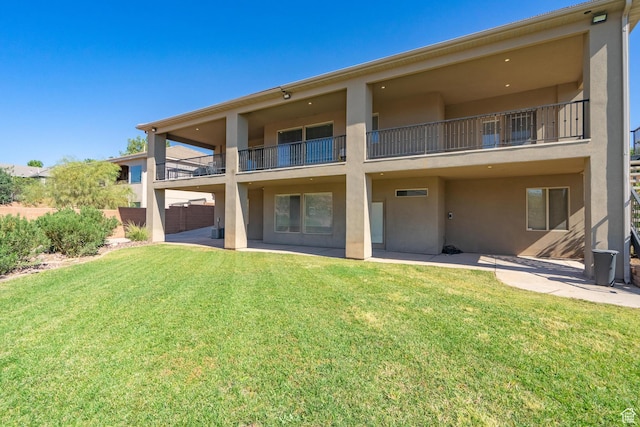 2042 Westcliff Dr, St George, UT 84790 - rear view of property with a balcony, a yard, and stucco siding
