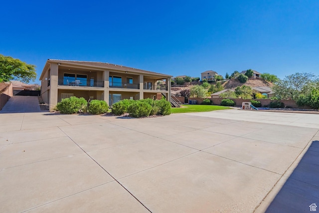 2042 Westcliff Dr, St George, UT 84790 - view of front of house with stairs, stucco siding, and fence