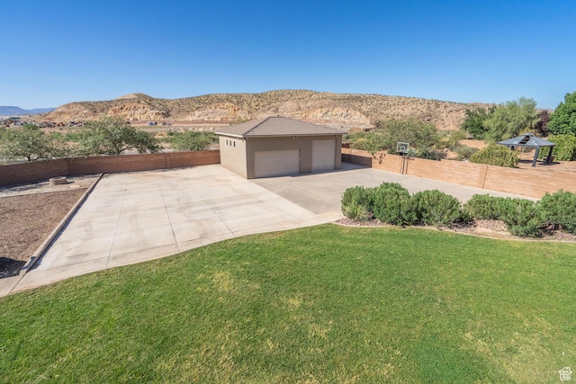 2042 Westcliff Dr, St George, UT 84790 - exterior space featuring fence, a front lawn, stucco siding, a mountain view, and a garage