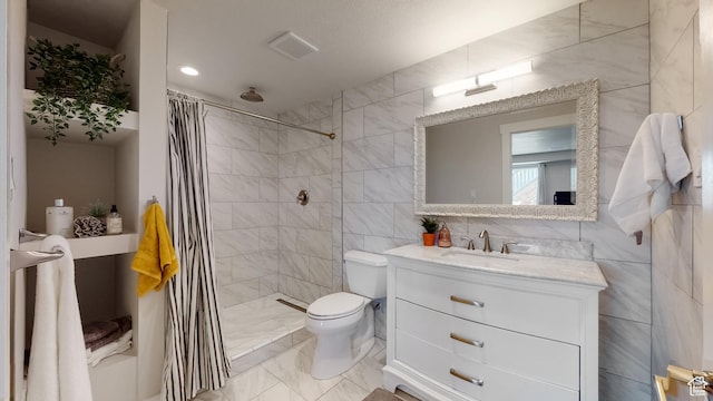 bathroom with tiled shower, marble finish floor, tile walls, toilet, and vanity