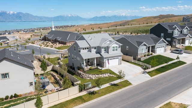 bird's eye view featuring a residential view and a water and mountain view