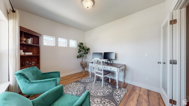office area featuring wood finished floors and baseboards