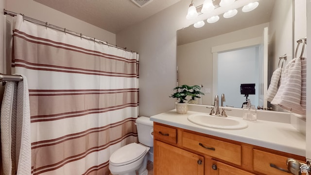 bathroom featuring visible vents, toilet, a shower with curtain, and vanity