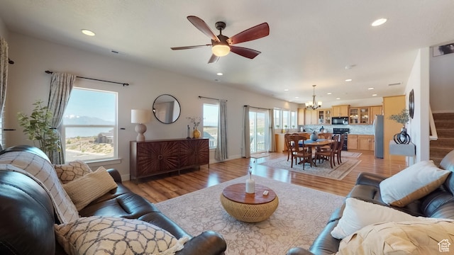 living room with baseboards, recessed lighting, and light wood-style floors