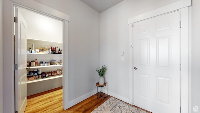 entryway featuring baseboards and light wood-type flooring