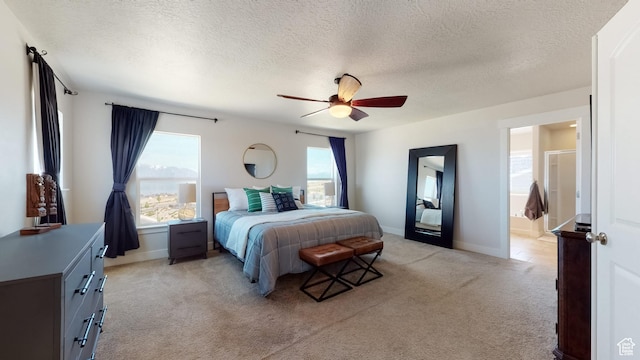 bedroom with a textured ceiling, ceiling fan, light carpet, and baseboards
