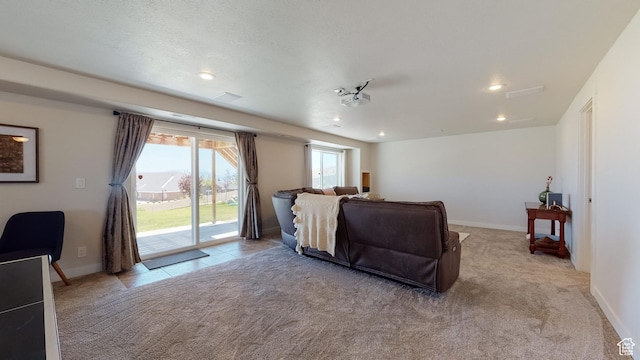 living room featuring recessed lighting, baseboards, and light carpet