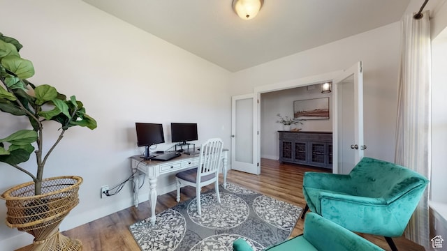 office space with wood finished floors and baseboards