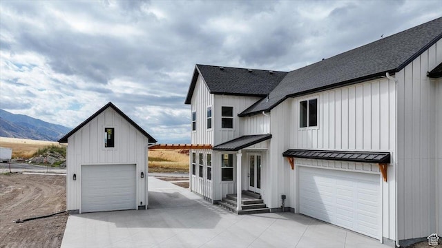 1153 E 160 N, Hyde Park, UT 84318 - view of front facade featuring a standing seam roof, roof with shingles, board and batten siding, and a mountain view