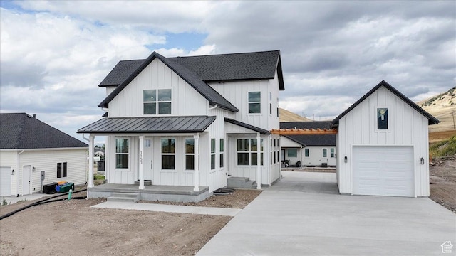 1153 E 160 N, Hyde Park, UT 84318 - modern inspired farmhouse with an attached garage, a standing seam roof, board and batten siding, and covered porch