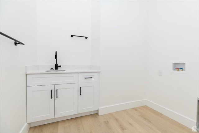 1153 E 160 N, Hyde Park, UT 84318 - laundry area with light wood finished floors, a sink, baseboards, washer hookup, and cabinet space