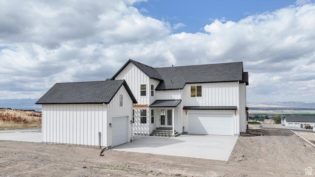 1153 E 160 N, Hyde Park, UT 84318 - modern inspired farmhouse with board and batten siding, metal roof, a garage, a standing seam roof, and roof with shingles