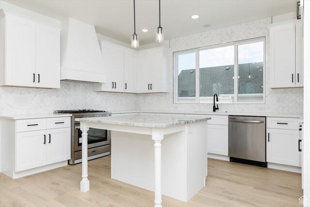 1153 E 160 N, Hyde Park, UT 84318 - kitchen featuring decorative backsplash, white cabinetry, custom exhaust hood, and stainless steel appliances