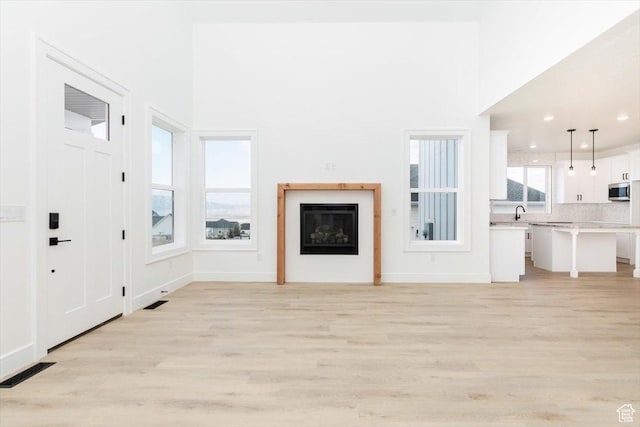 1153 E 160 N, Hyde Park, UT 84318 - unfurnished living room featuring recessed lighting, light wood-style flooring, visible vents, and baseboards