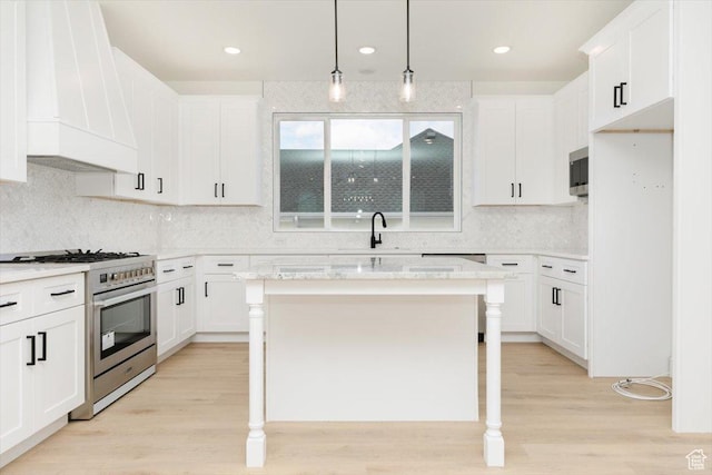 1153 E 160 N, Hyde Park, UT 84318 - kitchen with light wood-type flooring, stainless steel appliances, custom range hood, backsplash, and white cabinetry