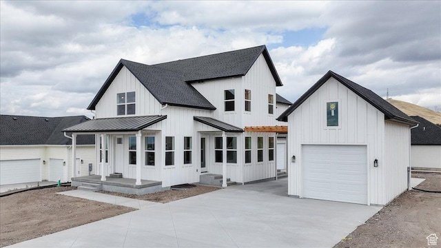 1153 E 160 N, Hyde Park, UT 84318 - modern farmhouse style home featuring concrete driveway, board and batten siding, a standing seam roof, an attached garage, and metal roof