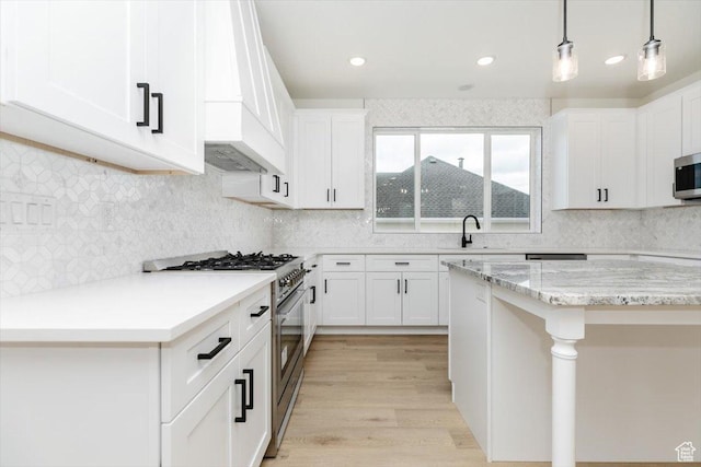 1153 E 160 N, Hyde Park, UT 84318 - kitchen with a sink, custom range hood, decorative light fixtures, white cabinets, and appliances with stainless steel finishes
