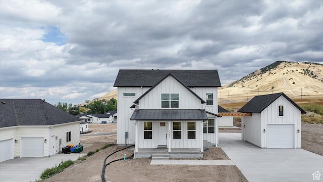 1153 E 160 N, Hyde Park, UT 84318 - modern farmhouse featuring a standing seam roof, driveway, metal roof, board and batten siding, and an outdoor structure