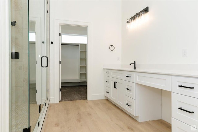 1153 E 160 N, Hyde Park, UT 84318 - full bathroom with a spacious closet, vanity, wood finished floors, and a stall shower