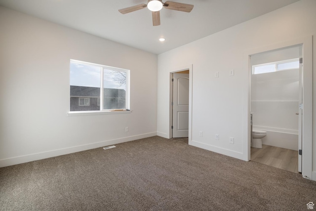 462 E 1035 S, Roosevelt, UT 84066 - unfurnished bedroom featuring multiple windows, carpet floors, and ensuite bath
