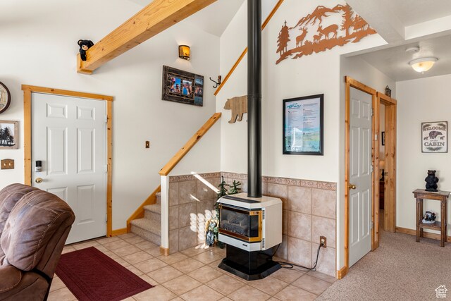 213 Lewis Loop Unit 38, Fish Haven, ID 83287 - tiled entrance foyer featuring a wood stove, beam ceiling, and tile walls