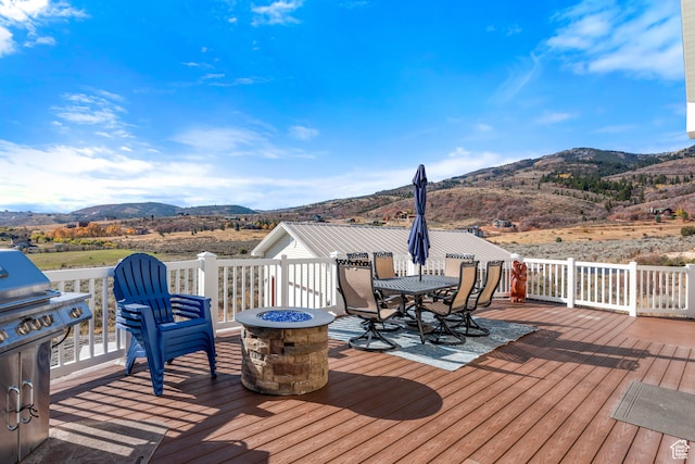 213 Lewis Loop Unit 38, Fish Haven, ID 83287 - wooden deck featuring a mountain view and an outdoor fire pit