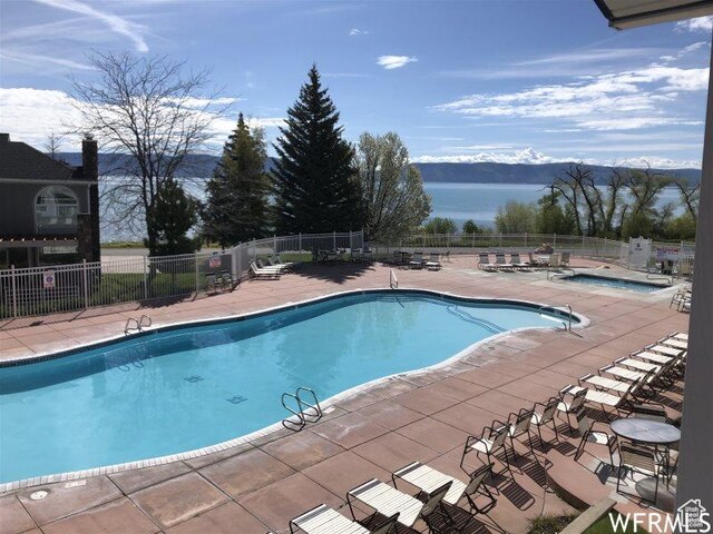942 N Newberg Dr Unit 2, Garden City, UT 84028 - community pool with fence, a patio area, and a water view