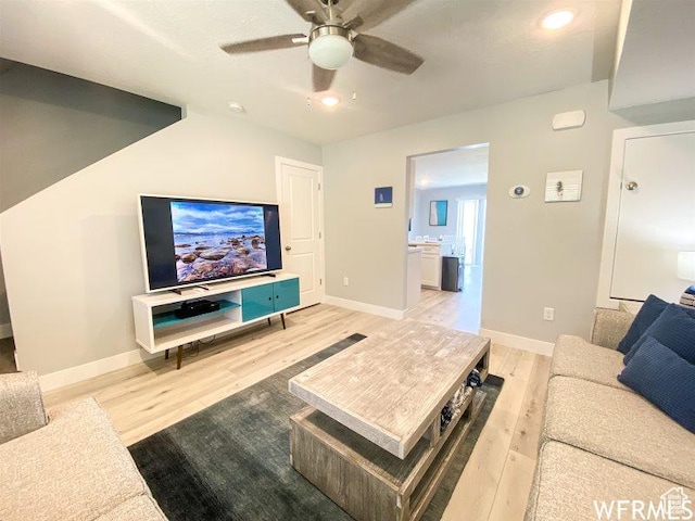 942 N Newberg Dr Unit 2, Garden City, UT 84028 - living room with baseboards, a ceiling fan, and light wood-style flooring