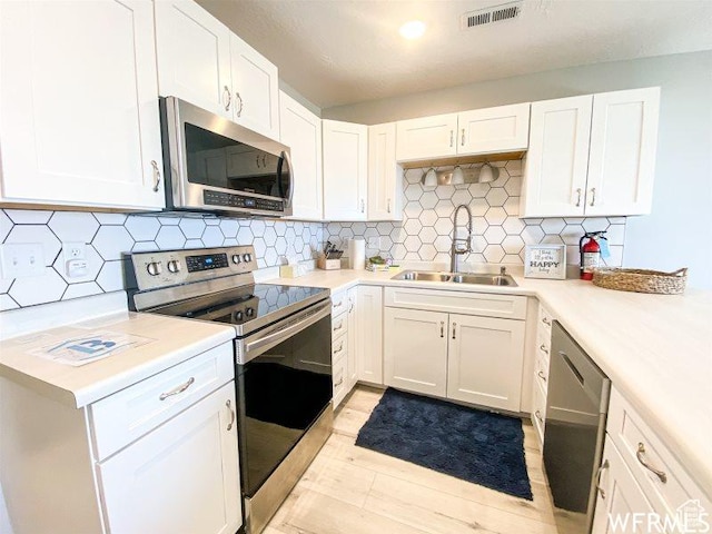 942 N Newberg Dr Unit 2, Garden City, UT 84028 - kitchen featuring appliances with stainless steel finishes, a sink, visible vents, and light countertops