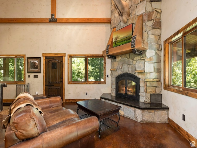 2050 W 2130 N, Helper, UT 84526 - living room with finished concrete floors, baseboards, a stone fireplace, and a healthy amount of sunlight