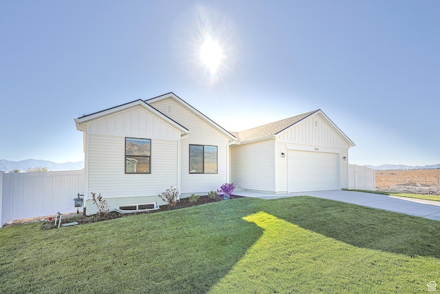 1131 W High Plains Dr Unit 601, Grantsville, UT 84029 - view of front of home with board and batten siding, an attached garage, concrete driveway, and a mountain view