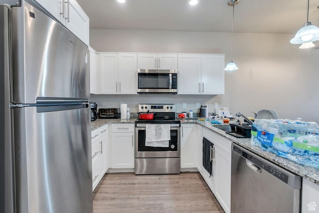 548 E 300 N, Vineyard, UT 84059 - kitchen with light wood-style floors, light stone countertops, appliances with stainless steel finishes, and white cabinetry
