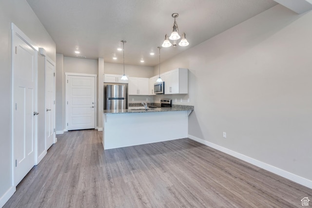 548 E 300 N, Vineyard, UT 84059 - kitchen with white cabinets, a sink, stainless steel appliances, baseboards, and wood finished floors