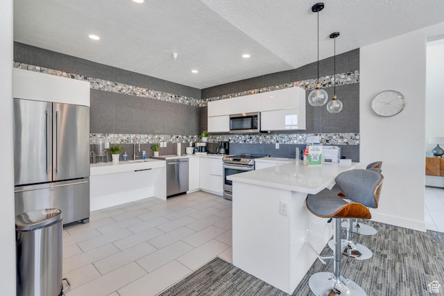 548 E 300 N, Vineyard, UT 84059 - kitchen with appliances with stainless steel finishes, white cabinetry, modern cabinets, and a peninsula